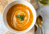 creamy roasted tomato soup in a bowl with olive oil drizzle and fresh basil, plant based tomato soup with roasted vegetables and soaked cashews, healthy protein tomato soup with vanilla protein blend, vegan creamy tomato soup with sourdough bread